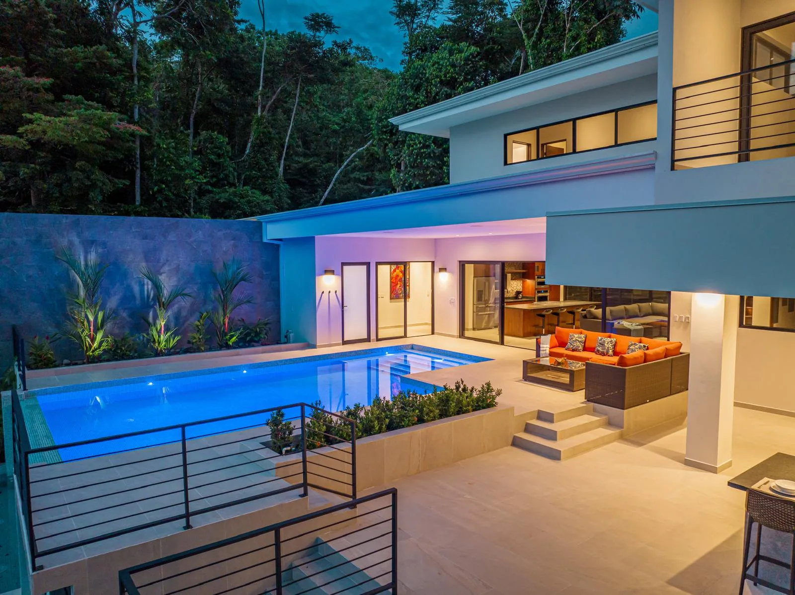 Outdoor living terrace at twilight with warm accent lighting
